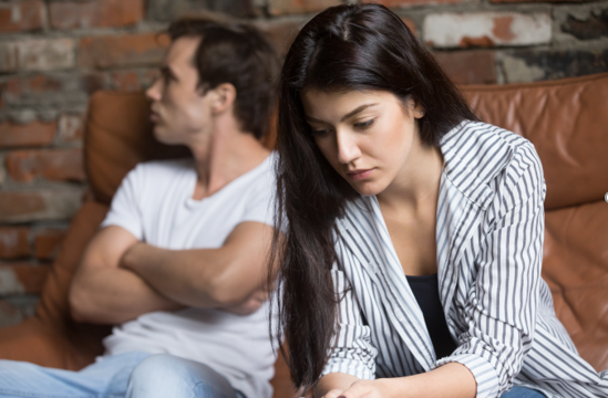 Evasive Couple Arguing on Couch