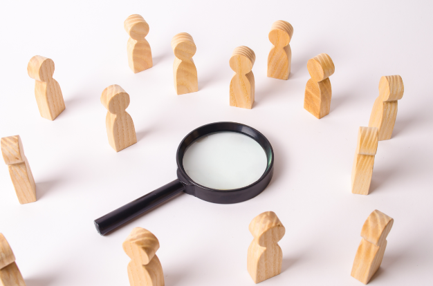 Magnifying Glass in Between Wooden Dolls